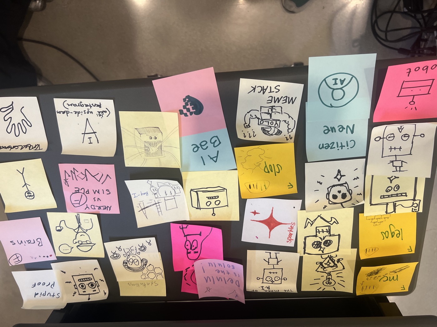 Sticky notes with hand-drawn icons on a table